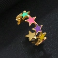 Macro shot of colorful star elements and gold-plated open ring on dark background - Pentagram