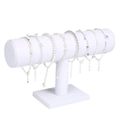 White T-bar display stand featuring multiple silver bracelets and star charms - White Velvet