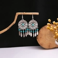 Detail of bohemian turquoise drop earrings with hollow floral design on a wooden branch - E2915-2/Hollow Disc Turquoise Leaf