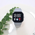 Detail view of square digital watch featuring astronaut graphics and gray silicone strap - Gray