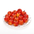 Artificial red mini apples with glossy finish arranged on a black checkered paper plate - Mini Red Yellow Apple
