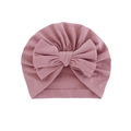 Soft dusty pink baby turban hat with a large bow decoration on white background - Taro