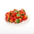 Realistic artificial red foam strawberries with green cloth leaves on white plate - Mini Strawberry