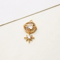 Detailed close-up of a gold Saturn-shaped pendant featuring sparkling clear zircon stones - Saturn Eight-pointed Star