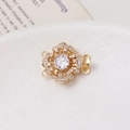 Macro shot of 14K gold-plated flower clasp with micro-set zircons for jewelry making - Camellia / Double Row / White