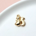 Close-up of a golden squirrel-shaped pendant charm on a white plate with pink background - 07# Squirrel