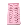 10 pairs of natural thin clear band false eyelashes on a pink base against white background - Slender Style (LK03)