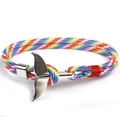 Close-up of rainbow braided paracord bracelet with a silver whale tail metal buckle clasp - Whale Tail - Rainbow