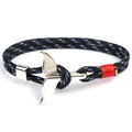 Macro detail of hand-woven black and blue paracord bracelet with silver whale tail clasp - Whale Tail - Black & Blue