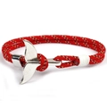 Detailed shot of red paracord bracelet featuring silver whale tail hook and woven accents - Whale Tail - Red Pattern