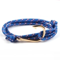 Close-up of blue braided nautical rope bracelet with a polished golden fish hook clasp - Blue/Red White Dots-Gold Fishhook