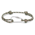 Macro shot of green braided RPET cord bracelet with silver metal D-ring locking clasp - No. 02 Green with Red & White Dots
