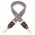 Detail of jacquard embroidered bag strap with premium leather ends and gold metal buckles - Coffee