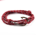 Close-up of red nautical braided rope bracelet with a silver metal fish hook clasp - Spotted Red