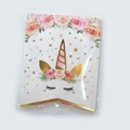 Close-up of unicorn birthday banner with pink flowers and gold horn in clear packaging - Bronzing Unicorn