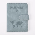 Close-up of gray-blue RFID passport holder featuring embossed map and aircraft design - Light Blue