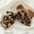 Detail of leopard print satin bow hair clip on elegant white fabric background - Light Brown Leopard