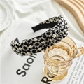 Detail of wide knotted headband with white floral embroidery on premium black fabric - Hollow Cloth Knotted Style / Black with White Flowers
