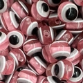 Macro detail of pink resin evil eye beads with striped patterns for DIY jewelry making - Pink