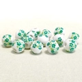 Detail of 10mm white ceramic beads with green floral pattern on textured fabric - Green Small Plum Blossom