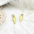 Macro shot of gold cone-shaped charms on white lace for DIY jewelry making - 3D Rhombus