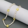 Dettaglio della collana di perle d'acqua dolce con margherite gialle su supporto - Giallo
