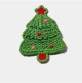 Detail of hand-knitted green Christmas tree hair clip with red star and ornaments - Knitted Christmas Tree
