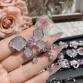 Macro shot of silver bow ring with pink center stone and sparkling teardrop pendants - Style 0242-Butterfly Shape With Pendant