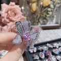 Macro view of bow ring featuring pink heart gemstone and sparkling pavé accents - Style 0253-Pink Heart Bow Knot