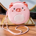 Pink plush pig-shaped crossbody bag for kids displayed on a decorative gold metal stand - Pink Pig