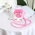 Pink plush unicorn crossbody bag for girls with gold horn and bow detail on white desk - Rose Red