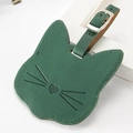 Detail of green cat-shaped leather luggage tag with secure metal buckle and strap - Green