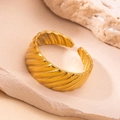 Detailed view of gold textured open ring on a minimalist sandstone background - Diagonal Wave