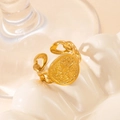 Macro detail of gold Cuban chain ring featuring a vintage star relief on a round plate - Star Cuban Chain - Gold