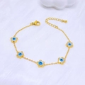 Goldenes Titanstahl-Armband mit blauen Muschel-Blumenanhängern auf weißem Seidenhintergrund - Fünfblättrige Blume