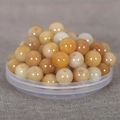 Macro shot of honey-colored natural stone round beads with holes for DIY jewelry making - 10mm / Natural Yellow