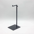 Side view of a sleek black metal L-shaped handbag display stand with a square base - L-Shape / Black