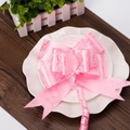 Close-up of pink decorative gift bow with rose patterns on elegant white ceramic plates - Rose Print Pink
