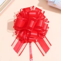 Detailed top view of a large red decorative ribbon flower with satin and mesh layers - Red