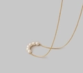 Elegant 18K gold-plated necklace featuring five white pearls on a fine minimalist chain - 5-Pearl Curved Design / Gold