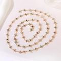 Detailed view of golden chain necklace with colorful evil eye cross charms in a spiral layout - Cross Evil Eye Chain