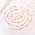 Detail of a long gold chain with white heart beads and small gold spheres in a spiral layout - White Heart Pearl Chain