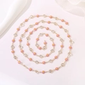 Close-up of pink daisy charm necklace with gold chain and sparkling rhinestones - Pink Daisy Rhinestone Chain