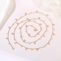 Detail of a gold body chain featuring hollow star pendants and clear crystal beads - Hollow Star Crystal Chain