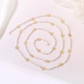 Close-up of elegant gold rose charms and white faux pearls on a versatile long necklace - Rose Flower Pearl Chain