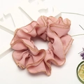 Pink chiffon scrunchie with gold trim and love decor on a clean white background - Pink