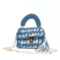 Detailed view of woven handbag featuring blue stripes, gold metal lock and chain strap - Blue White Gray Stripes