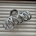 Macro detail of silver plated metal hair claw clip with spiral geometric design - Loop Ring Silver 13cm