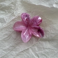 Detailed close-up of a pink marble flower hair claw clip with a glossy acetate finish - Rose Red