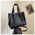 Quilted black tote bag with silver hardware and detachable shoulder strap on white backdrop - Black